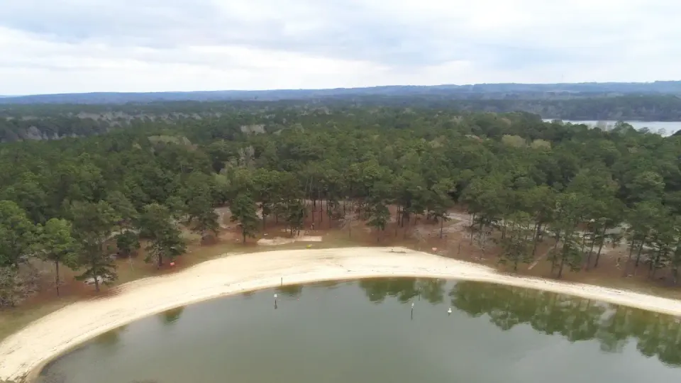 Aerial view of Cottonhill Campground overlooking swim beach in foreground and campsites in back ground.