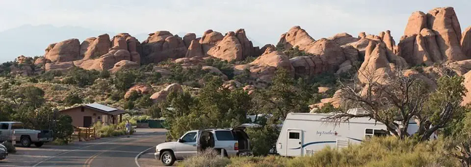 Campground road lined with campsites and boulders in the background