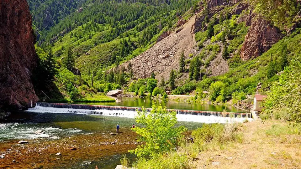 A view of historic East Portal with a fisherman dwarfed by canyon walls